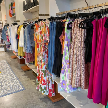 A wall of with racks and dresses