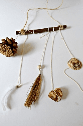 pine cones and feathers dangling